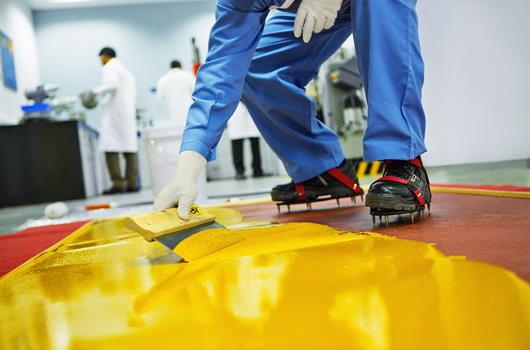 Worker renewing flooring.