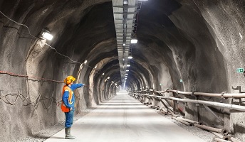 Worker pointing into a tunnnel